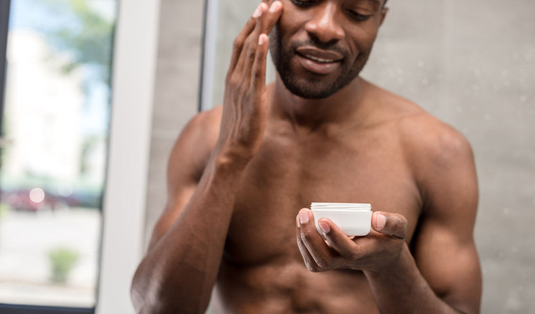 Guy applying moisturizer to face