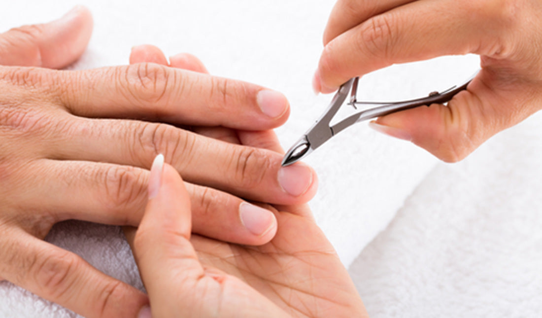 manicurist cutting off cuticle