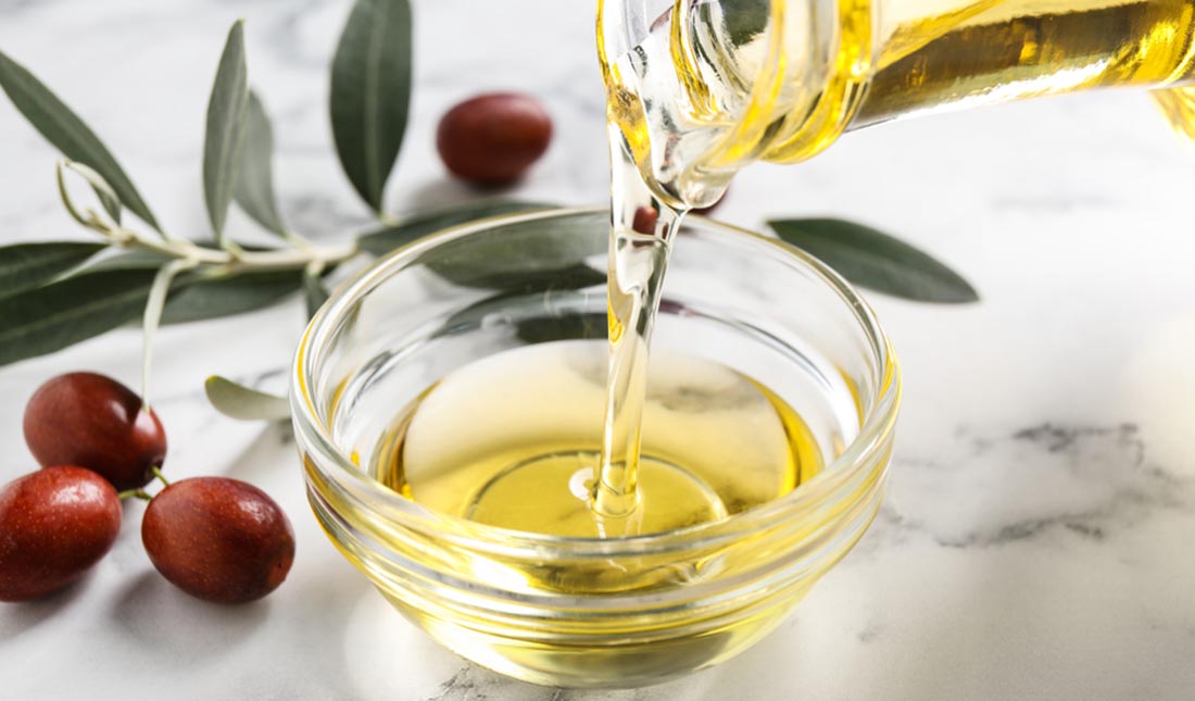 pouring olive oil into bowl