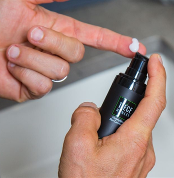 dispensing tiege hanley serum into hand