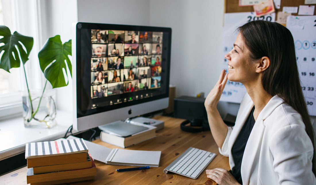 woman waving during zoom call