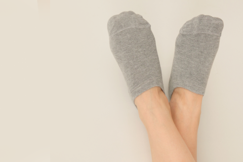 Person wearing comfortable gray no-show socks, perfect for everyday use.