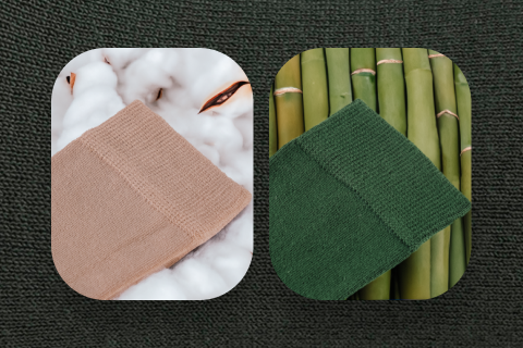 Pair of Hugh Ugoli bamboo socks presented on a cotton background next to bamboo stems, highlighting the natural and sustainable materials