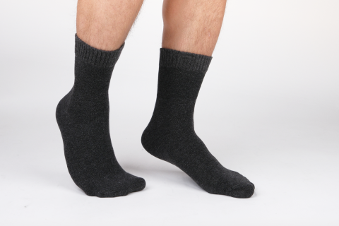 Close-up of legs wearing black Hugh Ugoli diabetic socks, showcasing comfort and support.