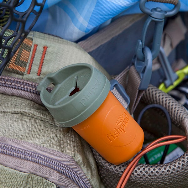 816332016011 PIO-CO Fishpond PIOPod 2.0 Cutthroat Orange Microtrash Container Pack it In Pack It Out Attached To Fishing Pack In The Wild