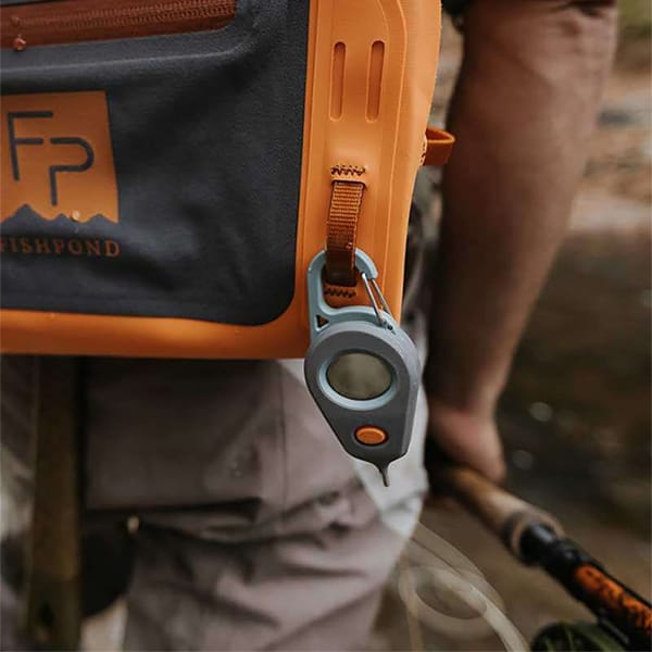 https://cdn.shopify.com/s/files/1/1946/9489/files/816332016202-Fishpond-Riverkeeper-Digital-Fly-Fishing-Stream-Thermometer-On-Fishpond-Thunderhead-Waist-Pack-In-The-Wild-Square-Opt.jpg?v=1704060144