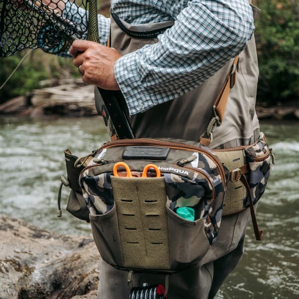 umpqua zs2 ledges 650 fly fishing waist pack on river with net in the wild