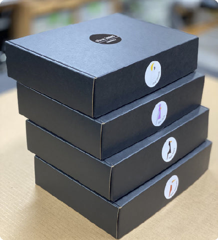 Stack of elegant black boxes with custom labels.