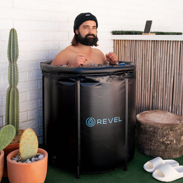 Man in a portbale ice bath. Recovery fitness, soothe sore muscles.