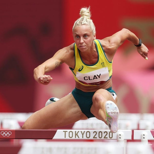 Liz Clay jumping over hurdle in the 2020 Tokyo Olympics