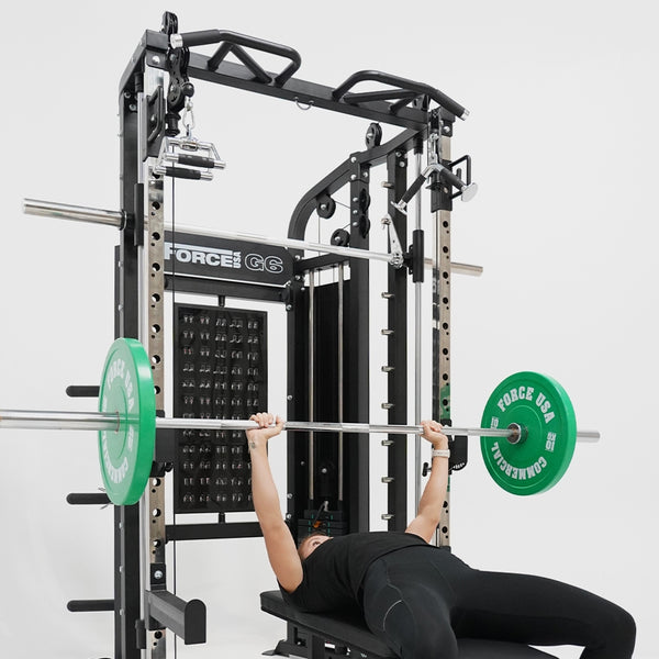 Woman doing a bench press on the Force USA G6 All-In-One Trainer 