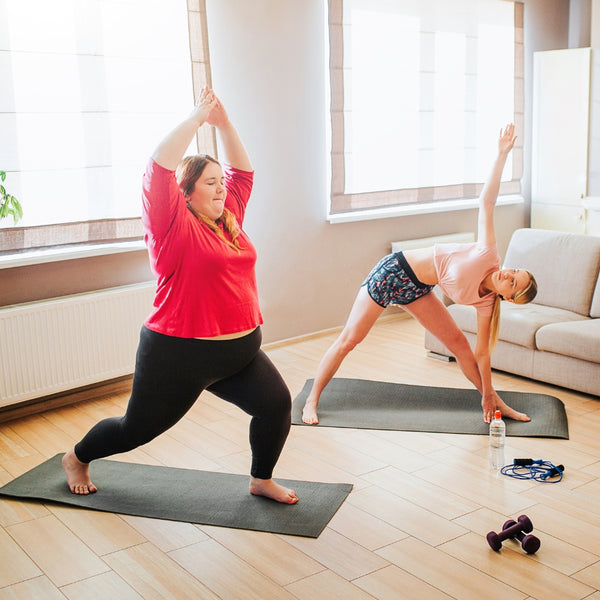 Overcoming workout anxiety - Two women practicing yoga at home