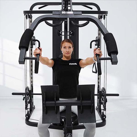 Woman performing press on Force USA Utility Home Gym | Gym and Fitness