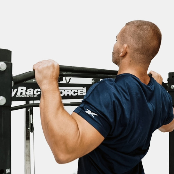 Man doing a pull up on the Force USA MyRack Squat Rack