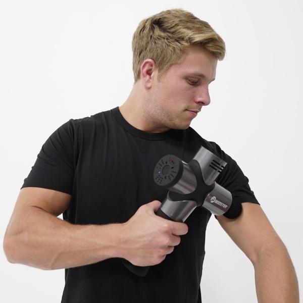 Man using Revel Recovery Massage Gun Pro on Shoulder