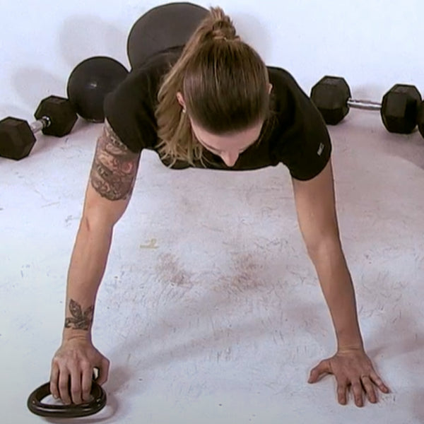 Lady doing a push up with a kettlebell in one hand