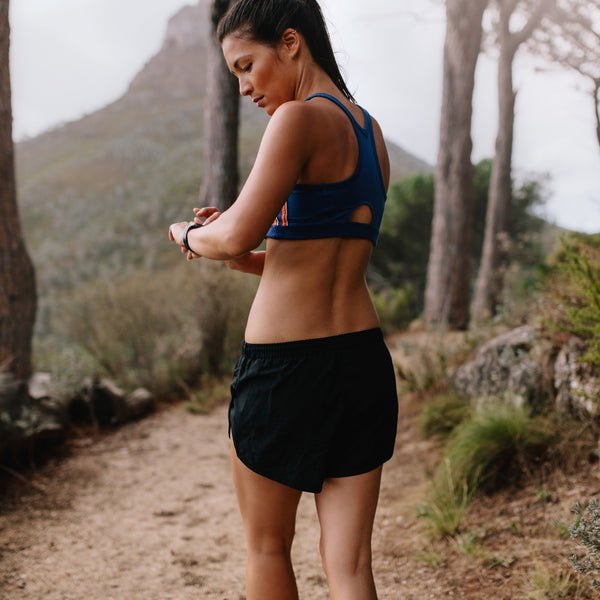 Woman running outdoors using her smartwatch