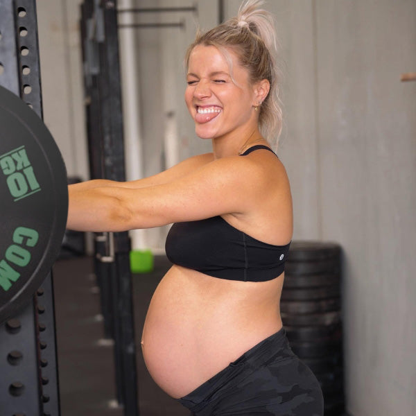 Lucy Young in front of barbell