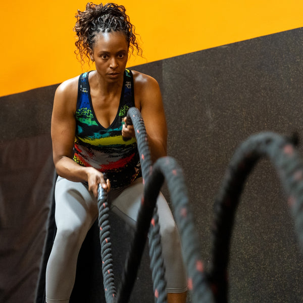 Woman using battle ropes in a gym