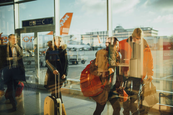 Airport passengers with carry on luggage