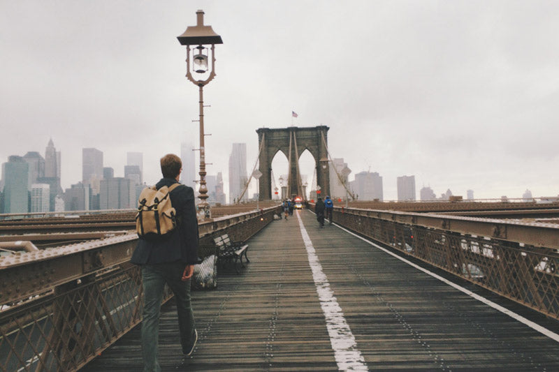 Man with a backpack on Brooklyn bridge