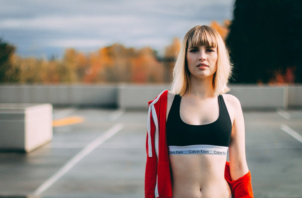 Woman in sports bra and a jacket