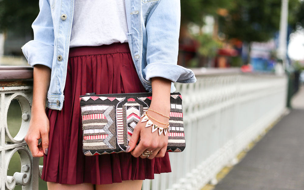 Woman in shirt and dress combo, layered with a denim jacket