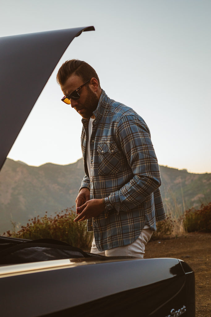 Unbutton Flannel looking into the trunk of a car