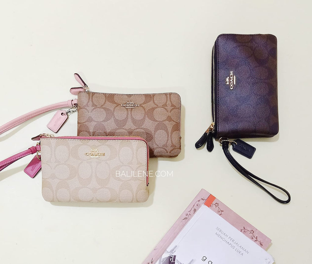 brown and pink coach wristlet