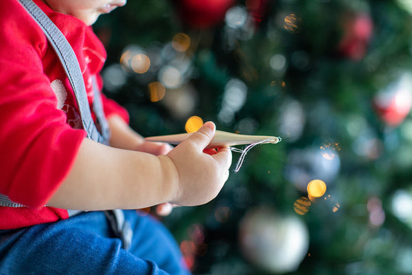 Baby holding an ornament