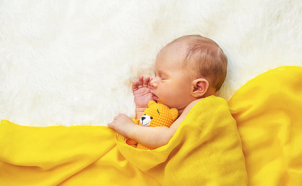 Baby sleeping with teddy bear