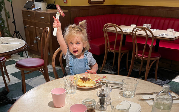 Girl holds up sausage