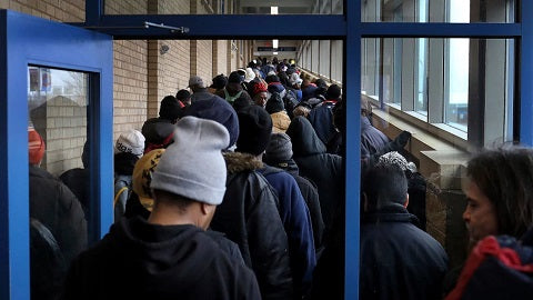 Long line for lunch at Sharing Caring Hands in Minneapolis