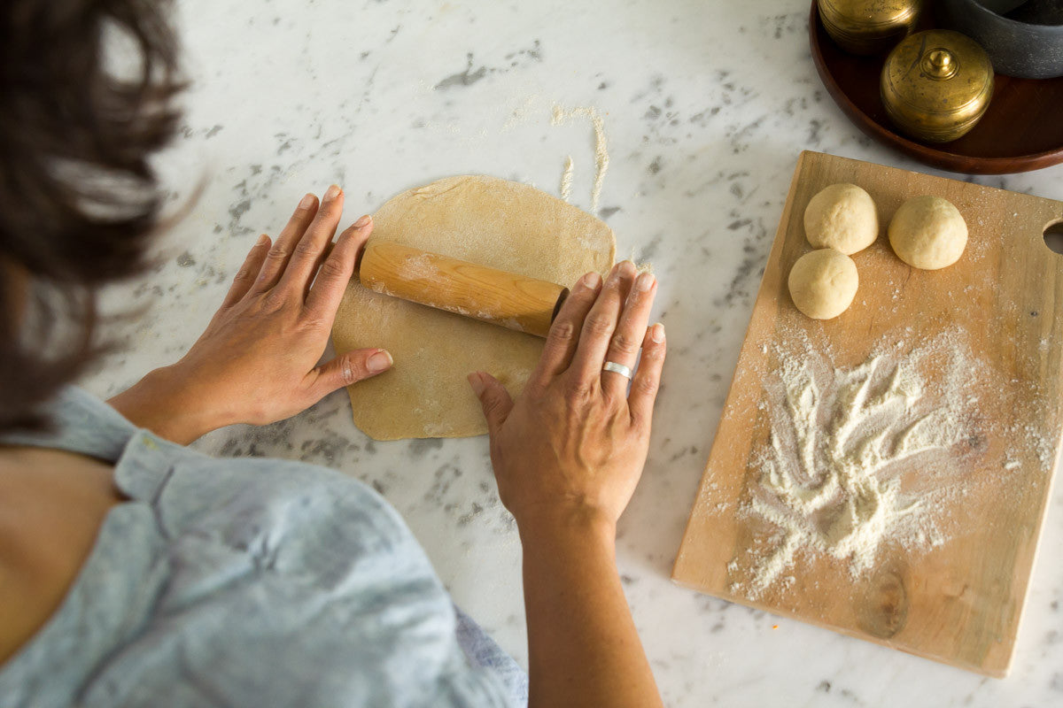 Paula rolling dough on kitchen table