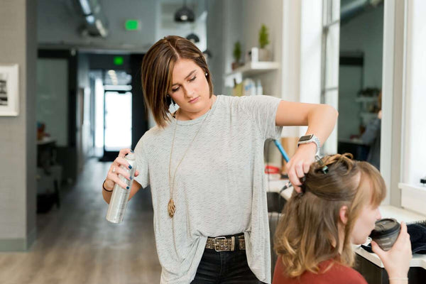 a beautician doing a woman’s hair
