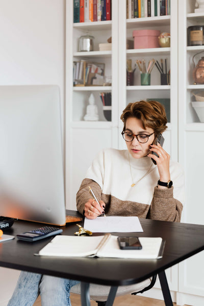 a businesswoman talking on the phone in a casual office