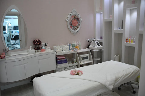 A room with a massage bed and beauty products