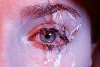 water pouring down a woman’s eyelashes