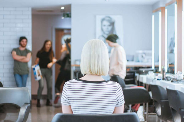 a woman waiting for an appointment in a beauty salon