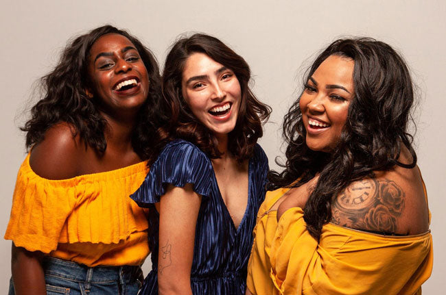 Three women laughing together