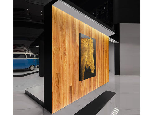 An interior wall with a art pieces is lighted up by a wall washing light at the top downward in an exhibition space