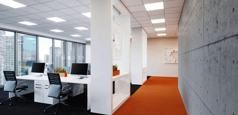 LED panel lights installed on the ceiling of an office area are illuminating the space