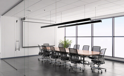 Two 8ft long GL LED linear lights are suspended from ceiling of a conference room