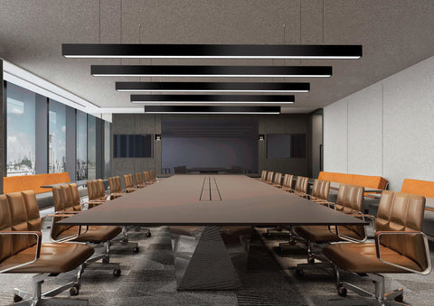 Some LED linear lights suspended from a ceiling of a conference room to illuminate the space.