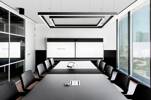 GL LED 8070 series L-shape and straight modules form a double square lights suspended in a meeting room.