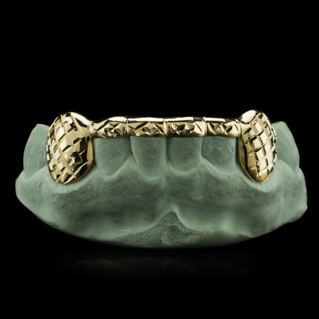 https://cdn.shopify.com/s/files/1/1957/5415/products/Gold-Diamond-Cut-Car-Connecting-Bridge-Grillz_1200x.jpg?v=1624519660