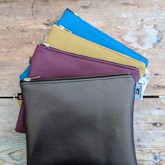 group of faux leather zipper clutch bags