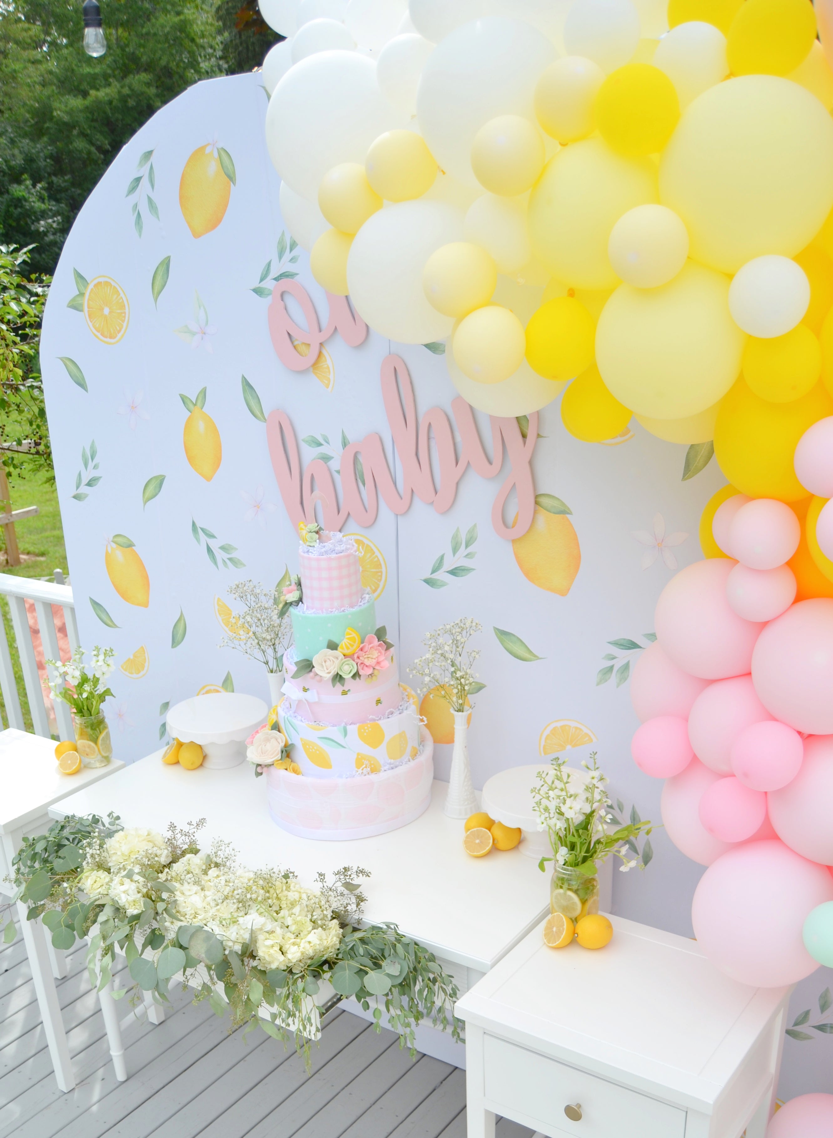 pink lemonade baby shower decoration table with balloon arch 