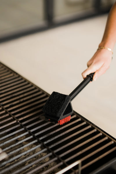 Using the red brush side of the Char-Griller 3-in-1 brush to clean grill grates