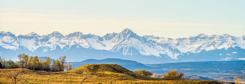 A breathtaking mountain range with snow-capped peaks in the background. UTV, spring break, UTV accessories